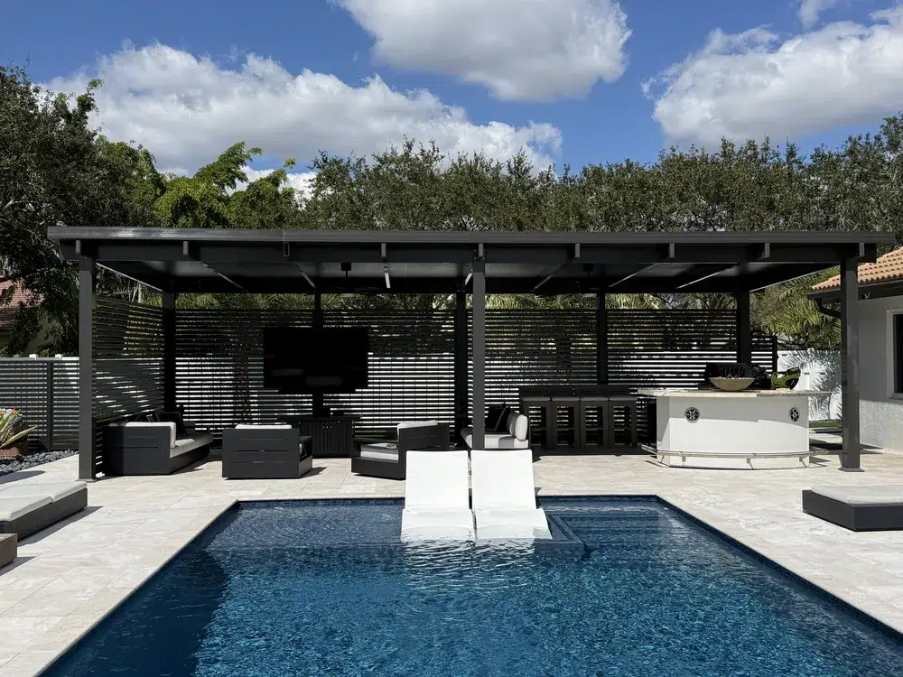 Residential pool deck with travertine pavers and outdoor seating