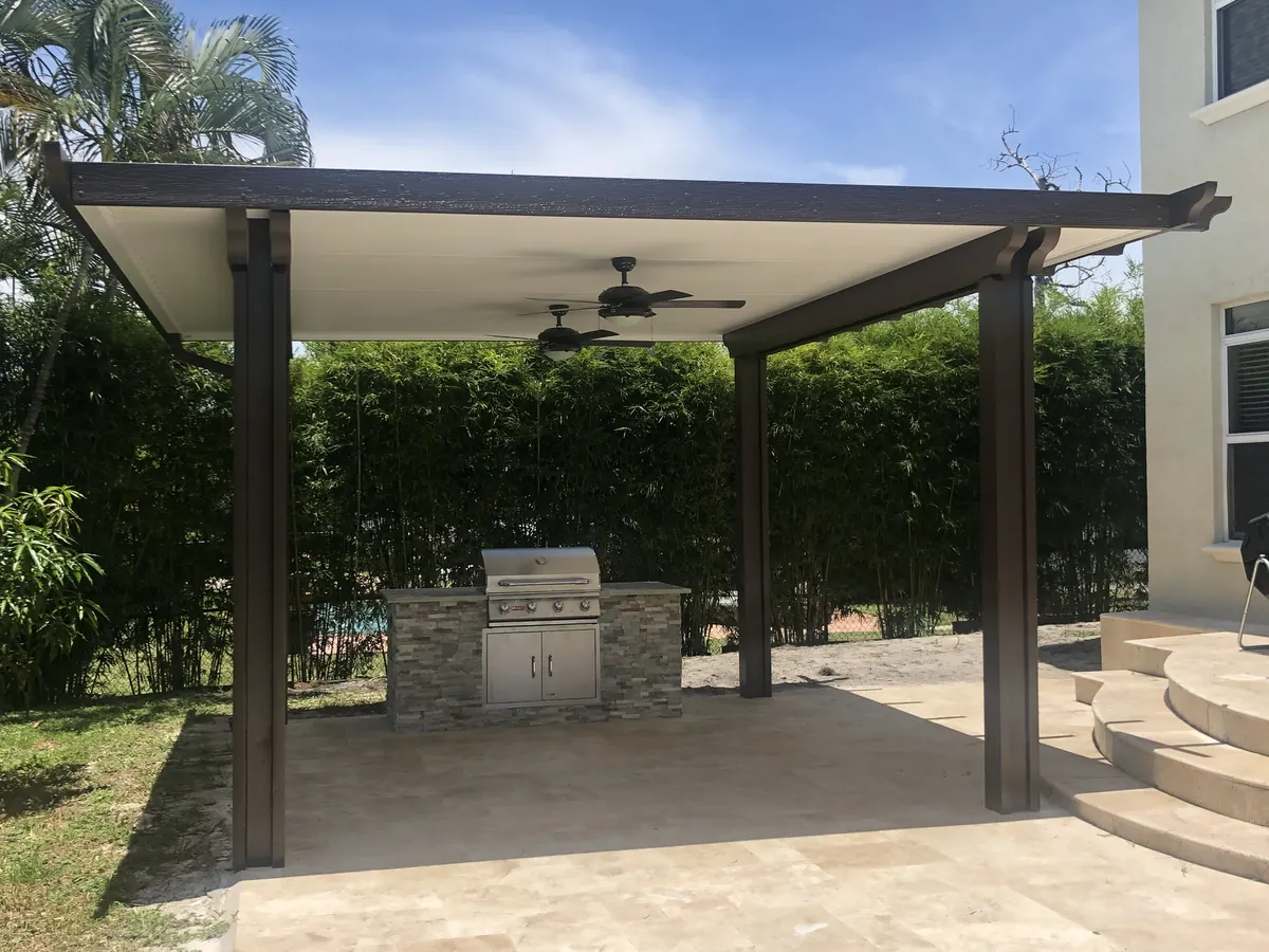 Outdoor living space with pergola, kitchen, and pool deck